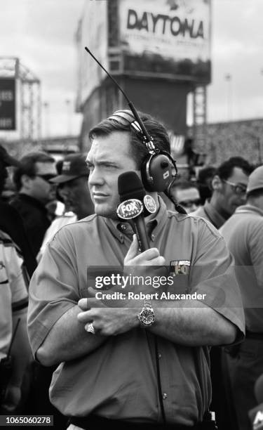 Fox Sports television broadcaster Matt Yocum prepares to talk with race drivers prior to the start of the 2002 Daytona 500 stock car race at Daytona...