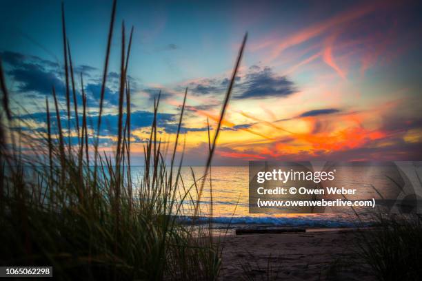 sunset on lake michigan - lake michigan stock pictures, royalty-free photos & images