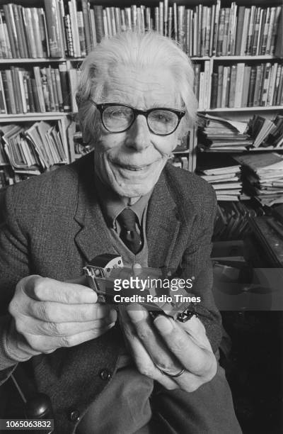 Portrait of author Wilbert Awdry, author of the 'Thomas the Tank Engine' books, holding a toy train, March 13th 1986.