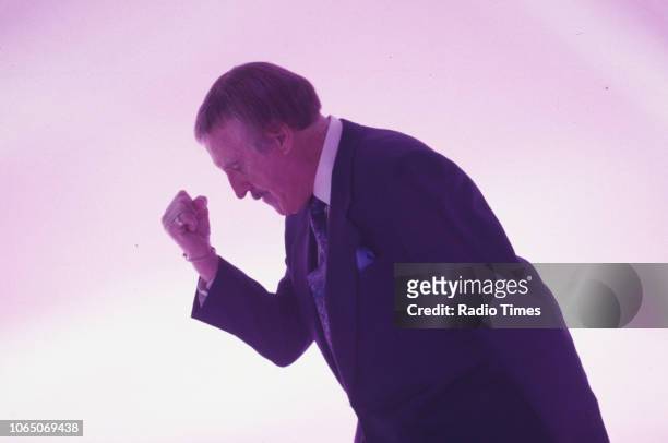 Entertainer Bruce Forsyth striking his famous pose while presenting the BBC television show 'The Generation Game', September 20th 1994.