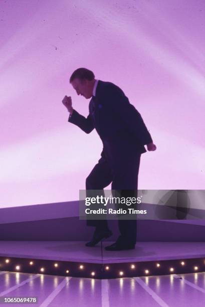 Entertainer Bruce Forsyth striking his famous pose while presenting the BBC television show 'The Generation Game', September 20th 1994.