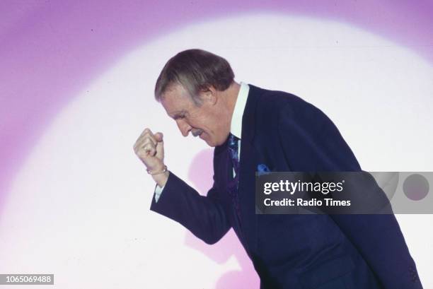 Entertainer Bruce Forsyth striking his famous pose while presenting the BBC television show 'The Generation Game', September 20th 1994.