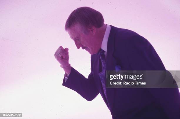 Entertainer Bruce Forsyth striking his famous pose while presenting the BBC television show 'The Generation Game', September 20th 1994.