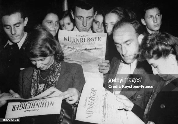 German People Reading The Reports Of The Trial Of Nazi Torturers.