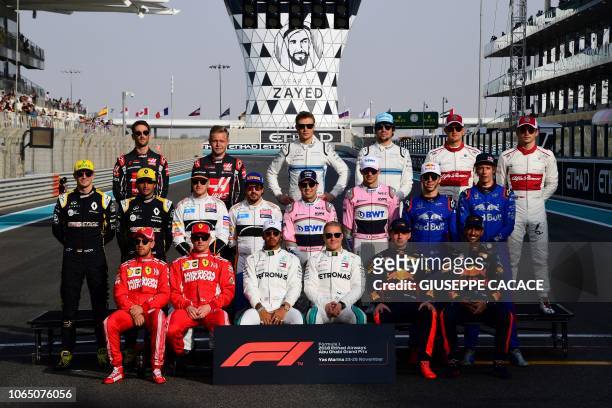 Formula One drivers, front row L-R: Ferrari's German driver Sebastian Vettel, Ferrari's Finnish driver Kimi Raikkonen, Mercedes' British driver Lewis...