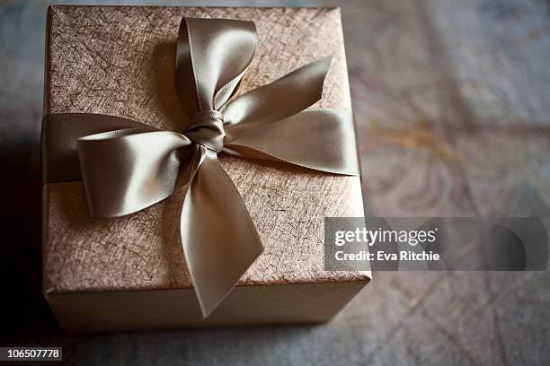 gold gift packaging for any occasion - gold satin ribon stock-fotos und bilder