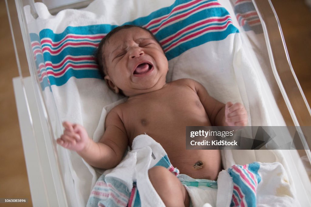 Mixed Race New Born Crying In A Hospitals Crib High-Res Stock