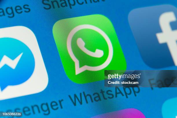 whatsapp, facebook, messenger and other cellphone apps on iphone screen - social media logos stock pictures, royalty-free photos & images