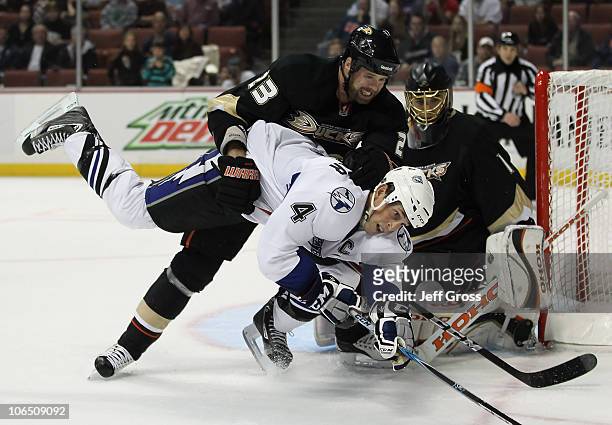 Vincent Lecavalier of the Tampa Bay Lightning is taken down by Paul Mara of the Anaheim Ducks, as goaltender Jonas Hiller of the Ducks defends in the...
