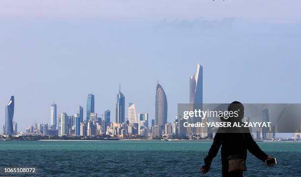 Kuwaiti woman walks along a beach in Kuwait City on November 25, 2018.