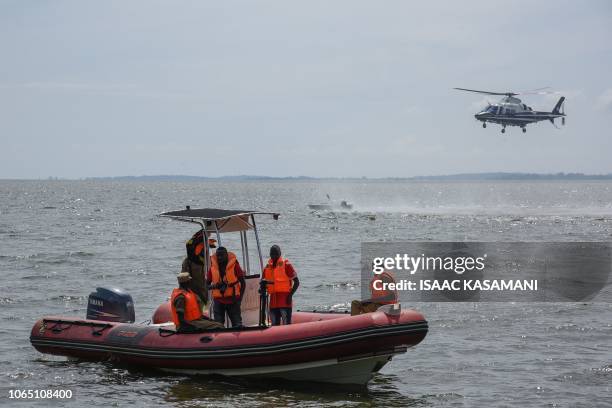 Rescuers search for victims at the site of a capsized cruise boat on Lake Victoria near Mutima village, south of Kampala, Uganda, on November 25,...