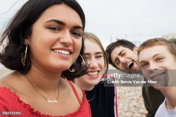 selfie taken by friends looking to camera on beach. - beach selfie bildbanksfoton och bilder
