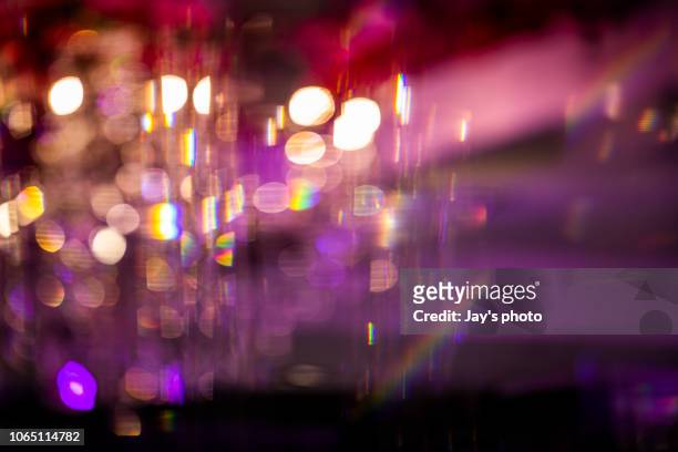 defocused image of illuminated city - glamour stock-fotos und bilder