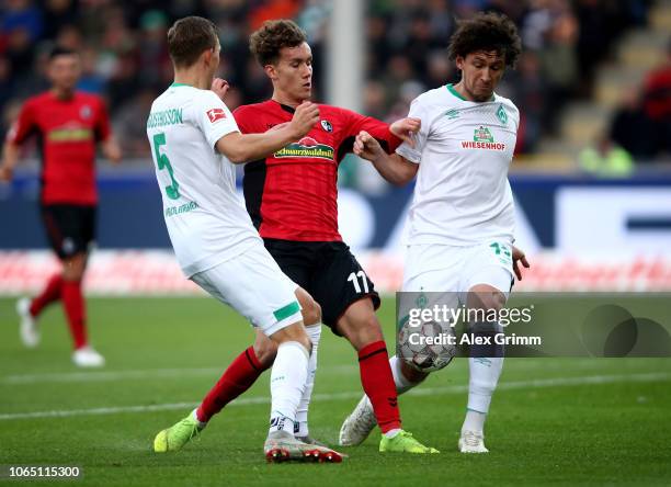Luca Waldschmidt of Freiburg challenges Ludwig Augustinsson and Milos Velijkovic of Bremen during the Bundesliga match between Sport-Club Freiburg...