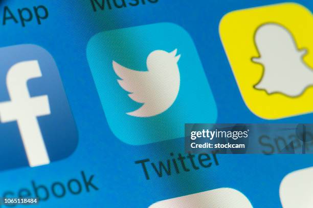 twitter, facebook, snapchat and other cellphone apps on iphone screen - snapchat stock pictures, royalty-free photos & images