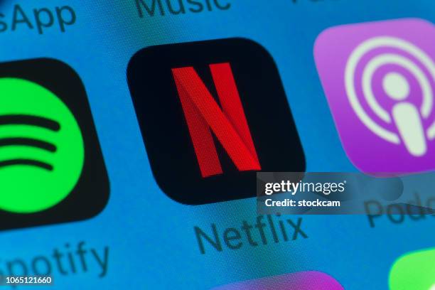 netflix, spotify, podcasts and other cellphone apps on iphone screen - netflix stock pictures, royalty-free photos & images