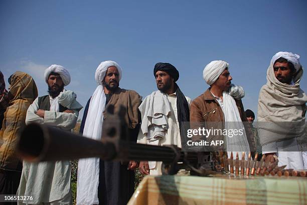 Surrendering Taliban militants stand with their weapons as they are presented to the media in Herat on November 4, 2010. Twenty Taliban fighters from...