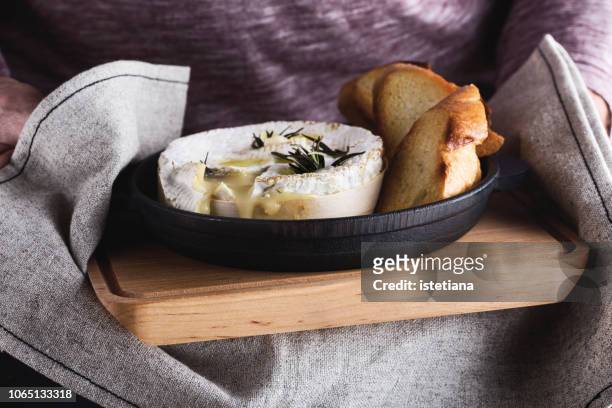 baked camembert with garlic and rosemary - camembert stock-fotos und bilder