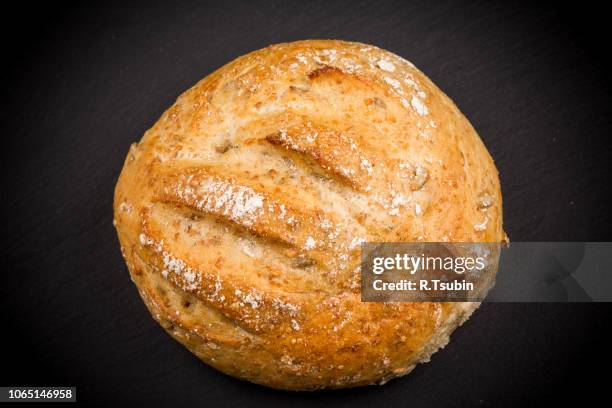 whole sesame roll on black slate board isolated on a white background - seeded stock pictures, royalty-free photos & images