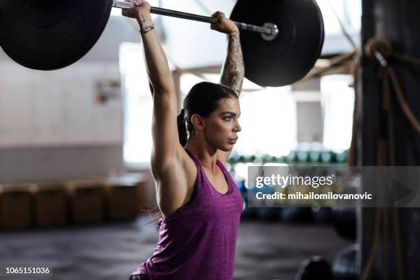 lifting barbell - weightlifting stock pictures, royalty-free photos & images