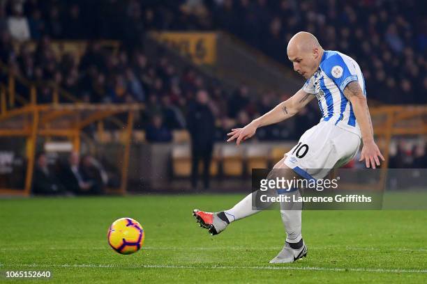 Aaron Mooy of Huddersfield scores his team's first goal during the Premier League match between Wolverhampton Wanderers and Huddersfield Town at...
