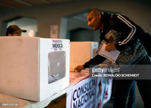 Mexican casts his vote, during a referendum at a polling station in Mexico City, on November 25, 2018. - Mexico's president elect Andres Manuel Lopez...