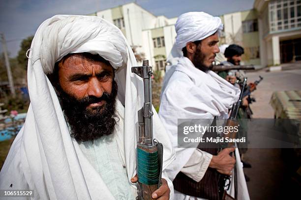 Surrendering Taliban militants stand with their weapons as they are presented to the media on November 4, 2010 in Herat, Afghanistan. Twenty Taliban...