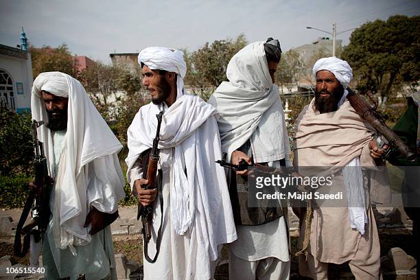 Surrendering Taliban militants stand with their weapons as they are presented to the media on November 4, 2010 in Herat, Afghanistan. Twenty Taliban...