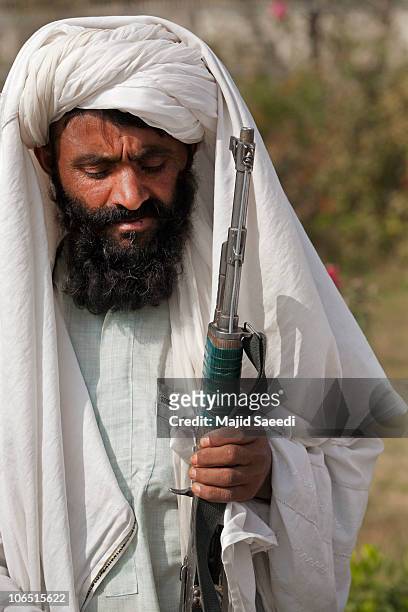Surrendering Taliban militants stand with their weapons as they are presented to the media on November 4, 2010 in Herat, Afghanistan. Twenty Taliban...