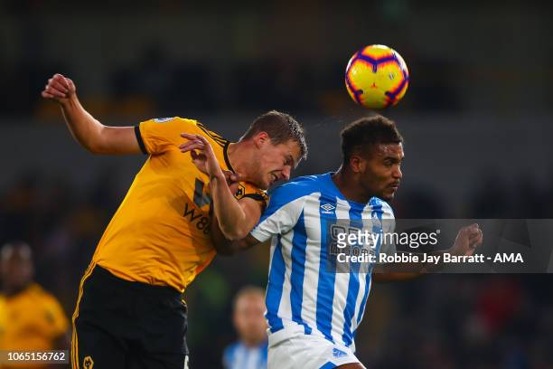 Ryan Bennett of Wolverhampton Wanderers and Steve Mounie of Huddersfield Town during the Premier League match between Wolverhampton Wanderers and...