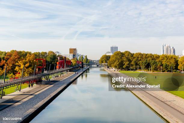 parc de la villette and water canal elevated view, paris, france - la villette stock-fotos und bilder