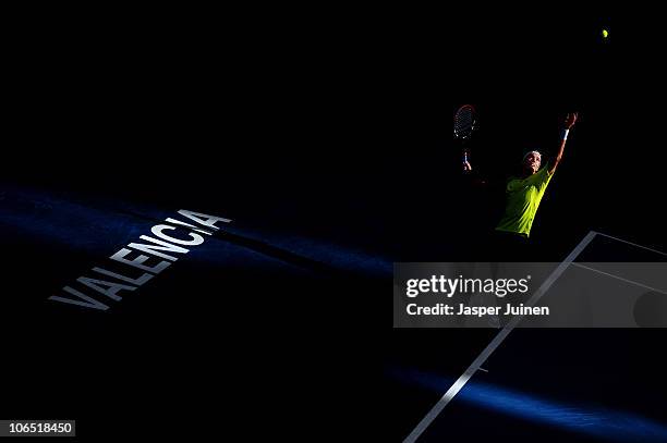 Juan Ignacio Chela of Argentina serves the ball to Nikolay Davydenko of Russia in his second round match during the ATP 500 World Tour Valencia Open...