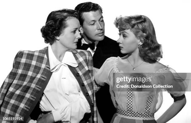 Actress Mary Astor Philip Dorn and Gloria Grahame in a scene from the movie"Blonde Fever"