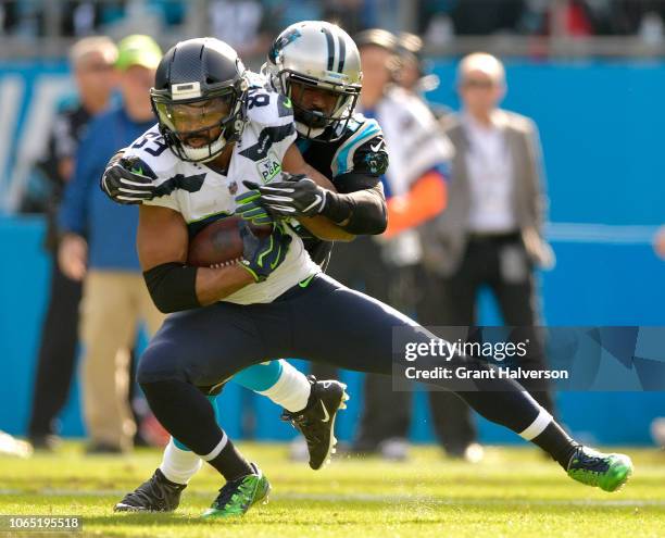 Doug Baldwin of the Seattle Seahawks makes a catch against Captain Munnerlyn of the Carolina Panthers during the first half of their game at Bank of...