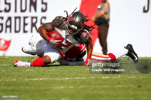 Running back Jacquizz Rodgers of the Tampa Bay Buccaneers brought down after a first down by defensive back Emmanuel Moseley of the San Francisco...