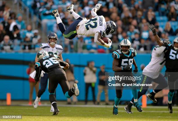 Chris Carson of the Seattle Seahawks runs the ball against Eric Reid and Thomas Davis of the Carolina Panthers in the third quarter during their game...