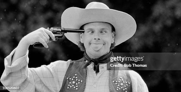 Paul Gasoigne of Tottenham Hotspur and England photographed as a cross-eyed cowboy with a gun to his head on 8th June 1989.