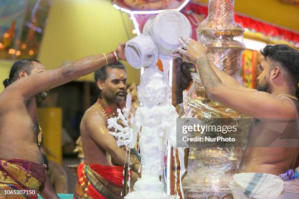 The idol of Lord Murgan is bathed with yogurt as Tamil Hindu priests perform a special abhishekam honouring Lord Murugan during the Sooran Por...