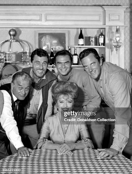 Actress Amanda Blake, Milburn Stone, Ken Curtis, Burt Reynolds, James Arness in a scene from the movie "Gunsmoke"