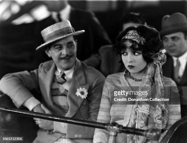 Actress Clara Bow and Henry Kolker in a scene from the movie "Rough House Rosie"