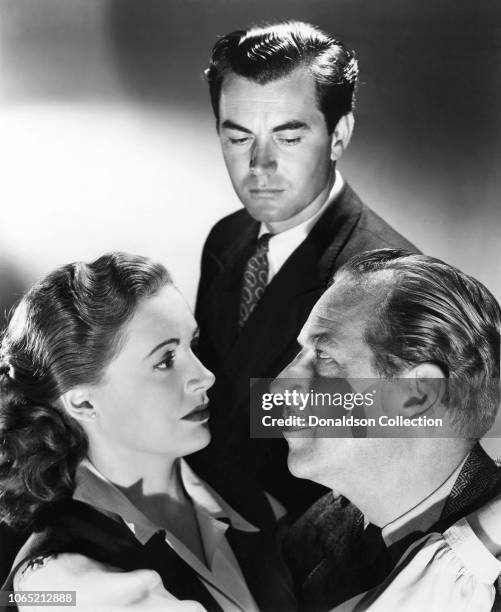 Actress Phyllis Calvert and Melvyn Douglas and Philip Friend in a scene from the movie "My Own True Love"