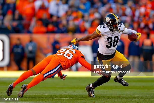 Running back Jaylen Samuels of the Pittsburgh Steelers avoids a tackle attempt by strong safety Darian Stewart of the Denver Broncos in the first...