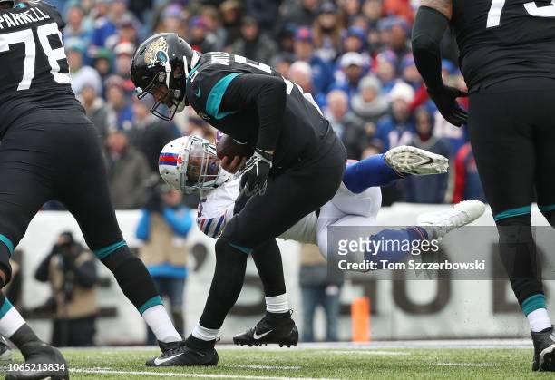 Blake Bortles of the Jacksonville Jaguars evades an attempted sack by Jerry Hughes of the Buffalo Bills in the first quarter during NFL game action...
