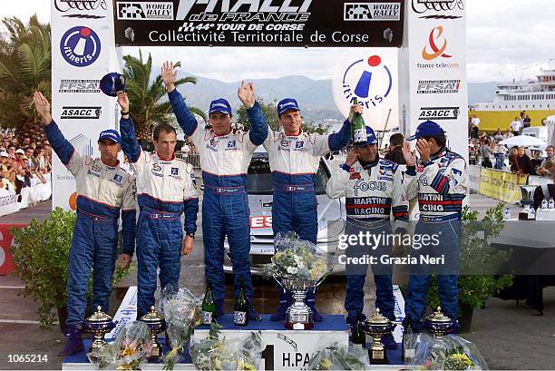 Gilles Panizzi of the Peugoet team celebrates on the podium after winning the Corsica Rally, Francois Delecour of the Peugoet team finished Second...
