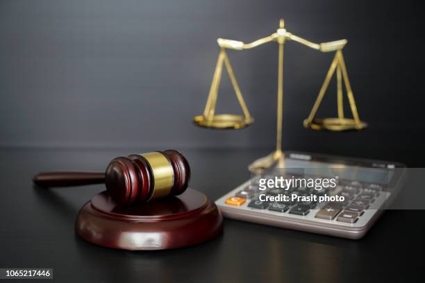 labor law concept, scale, gavel and calculator. - tax penalty stock pictures, royalty-free photos & images