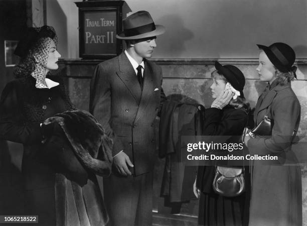 Actress Joan Crawford and Dana Andrews, Connie Marshall, Peggy Ann Garner in a scene from the movie "Daisy Kenyon"