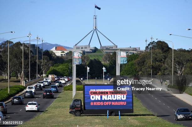 Billboard protesting the detention of children on Nauru sits outside of Parliament House on November 26, 2018 in Canberra, Australia. The Morrison...