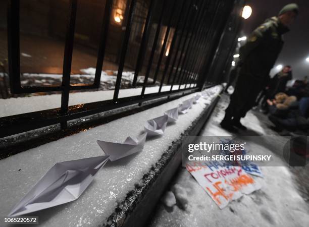 Paper boats are seen in front of the Russian Embassy in Kiev late on November 25 during a protest following an incident in the Black Sea off...