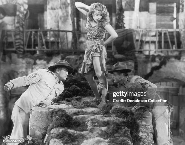 Actress Lili Damita and Victor McLaglen and Edmund Lowe in a scene from the movie "The Cock-Eyed World"