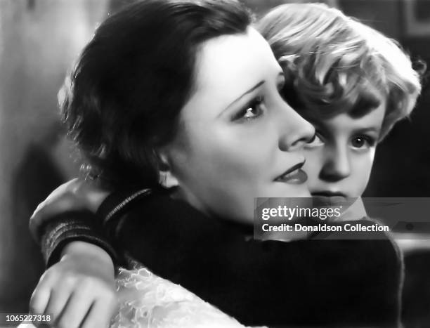 Actress Irene Dunne and Wally Albright in a scene from the movie "Thirteen Women"